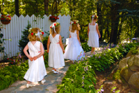 Flowergirls leading up to a wedding ceremony